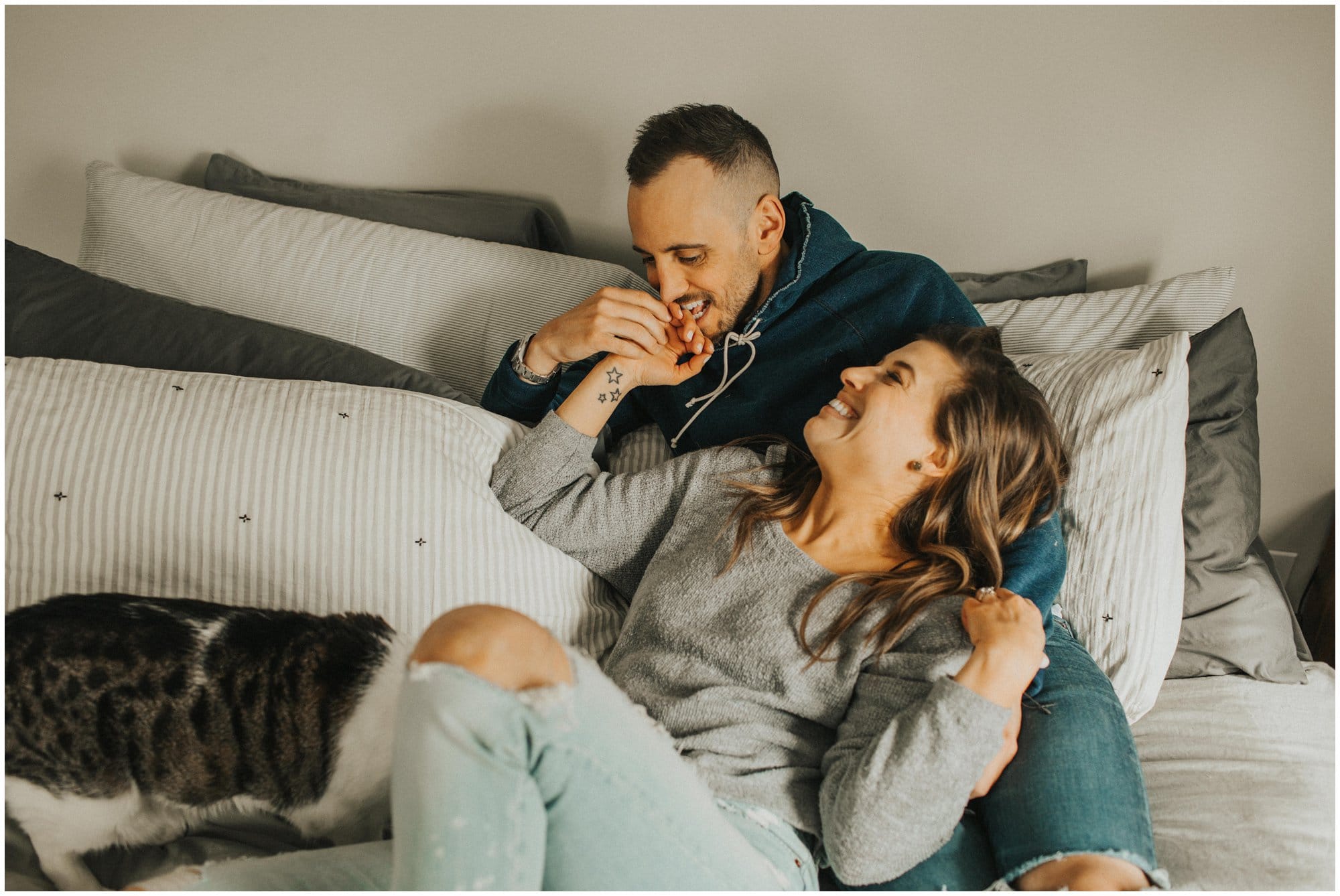 intimate at home fun engagement session in bedroom with cats