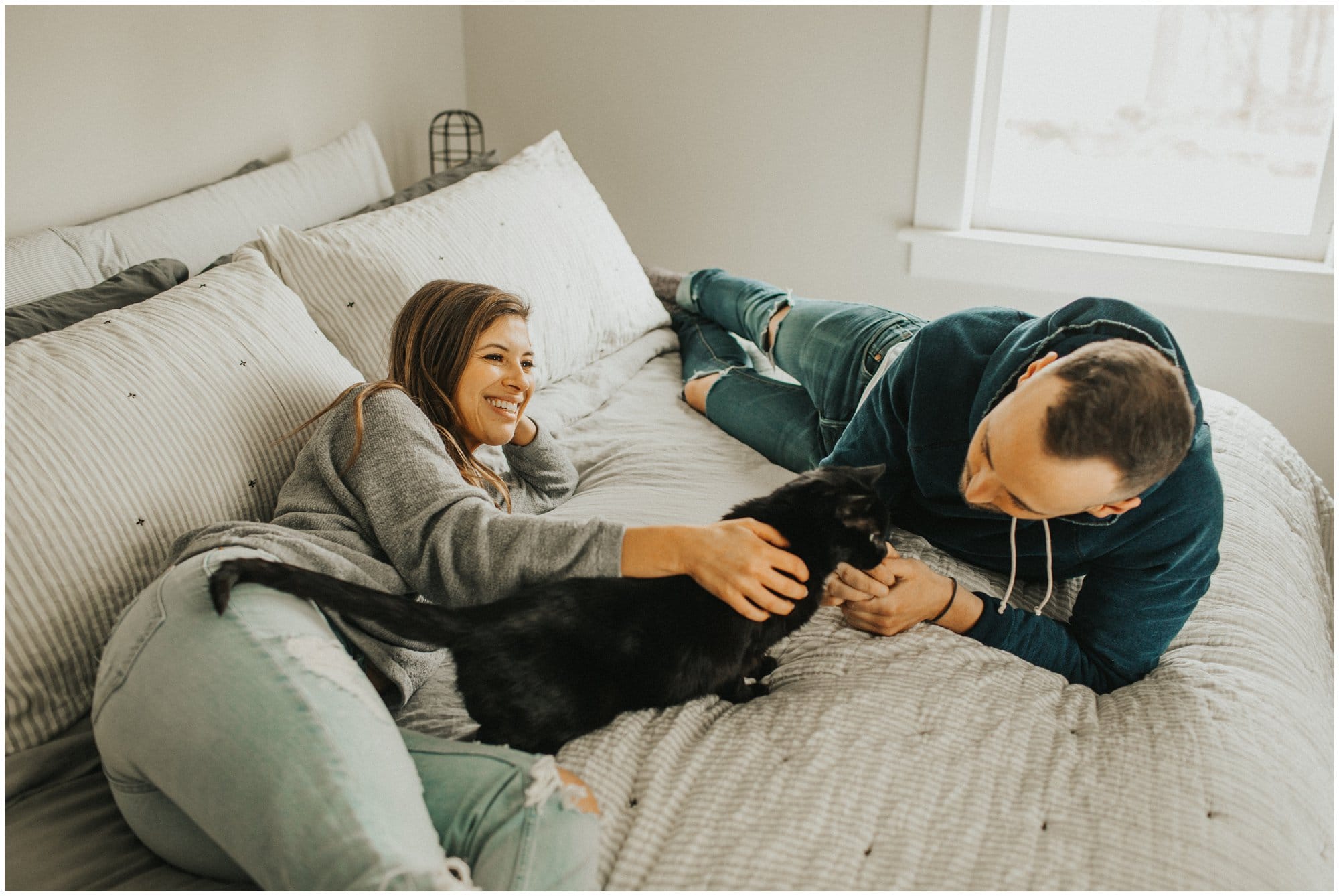 intimate at home fun engagement session in bedroom with cats